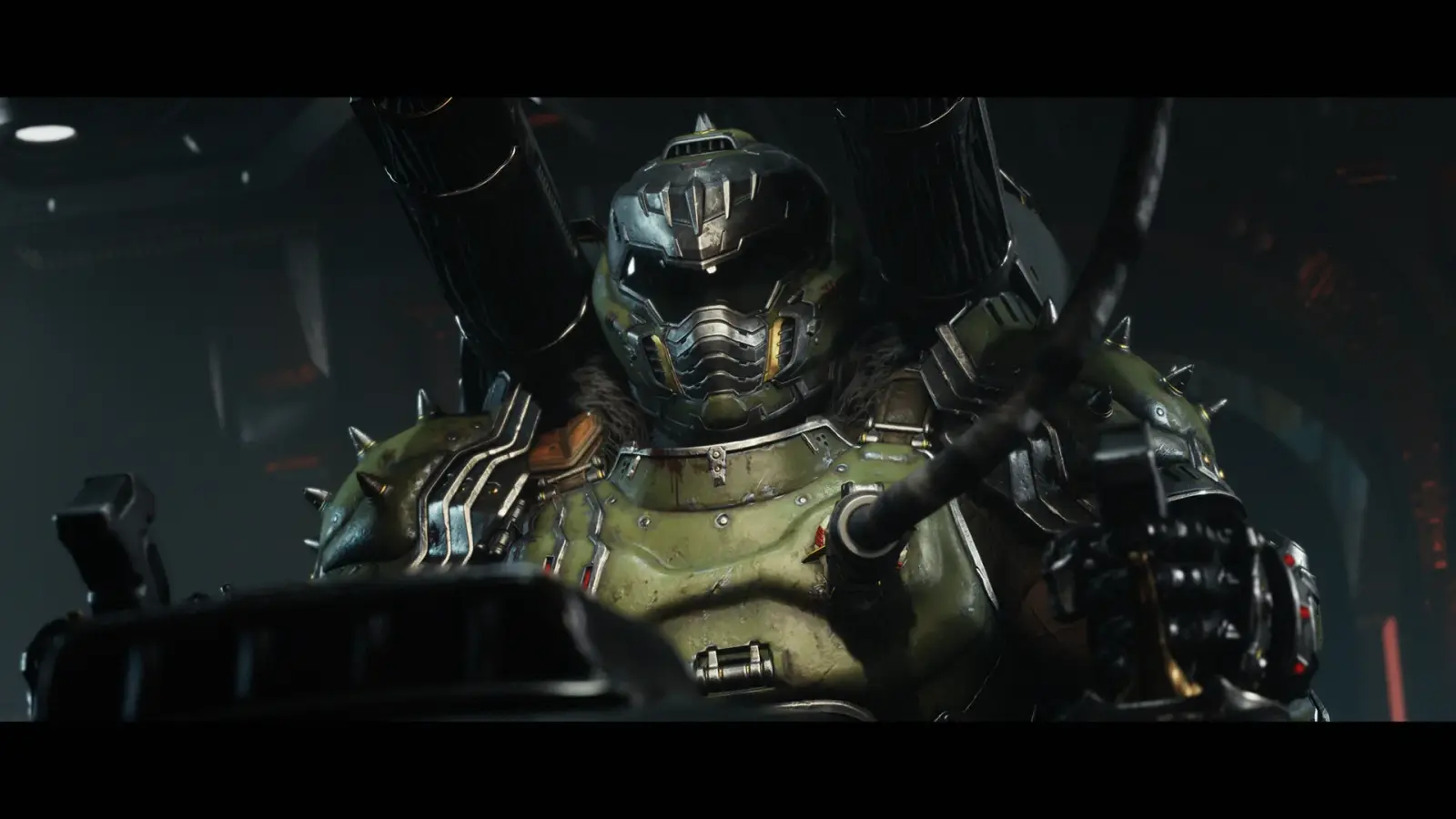 First-person combat shows the DOOM Slayer fighting demons with the Shield Saw and heavy weaponry.