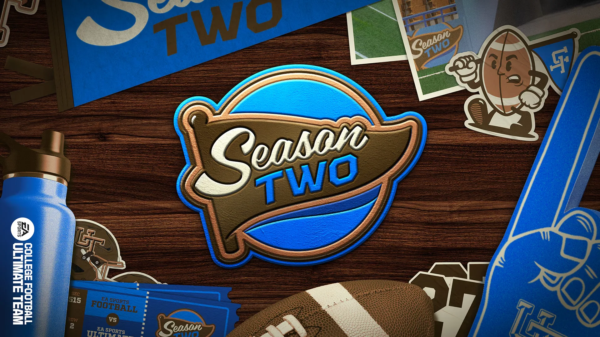 Promotional Season 2 graphic for EA SPORTS College Football 27 featuring a Season Two badge, water bottle, football, pennant, and mascot stickers on a wood tabletop