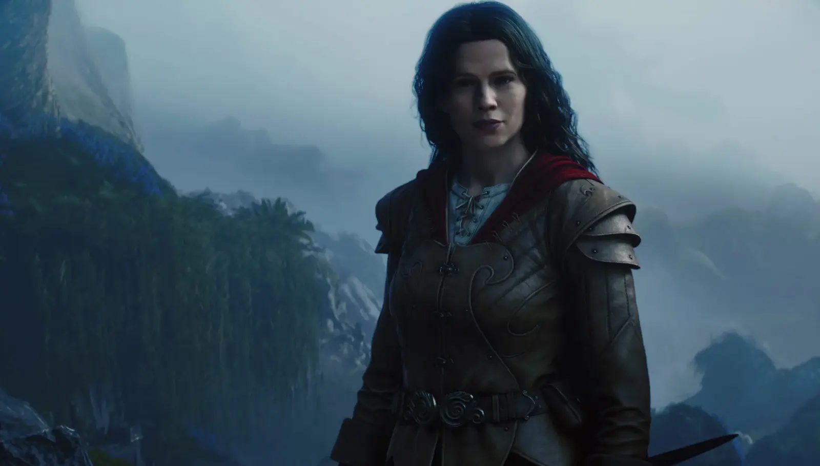 Isabel stands in leather and metal armor against a misty mountainous landscape.