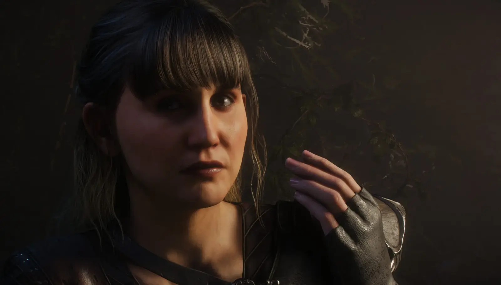 Jenny stands in a dark woodland setting wearing adventuring armor and fingerless gloves.