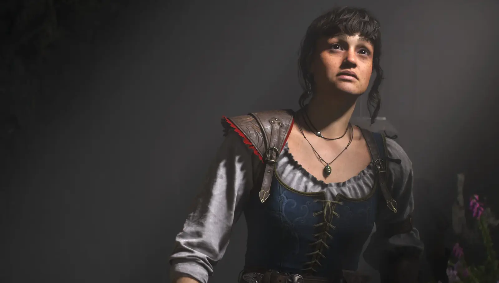A female Hero wearing leather adventuring gear looks upward inside a dimly lit environment.
