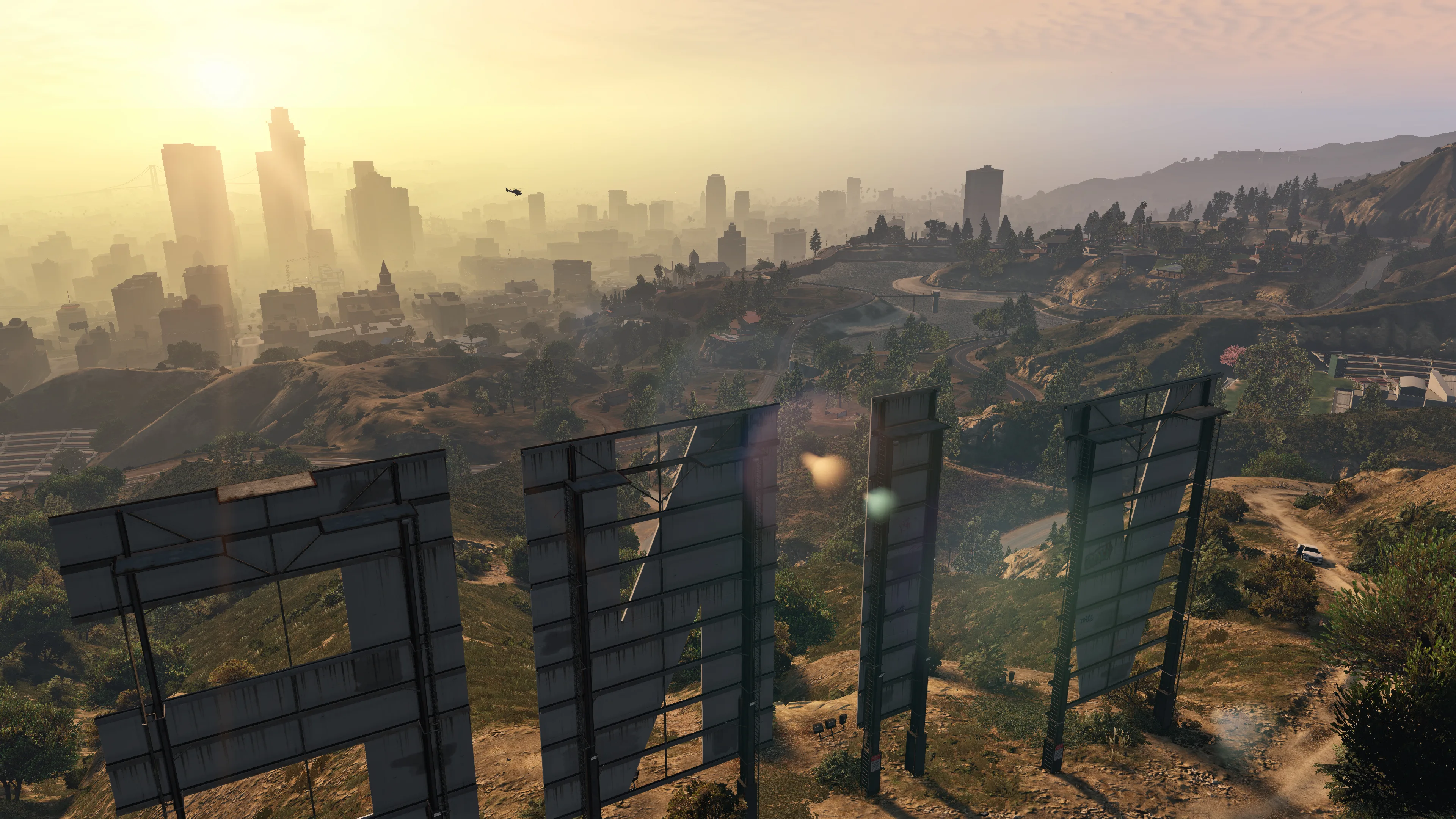 The Los Santos skyline stretches beyond hills and the back of the Vinewood sign in warm morning light.