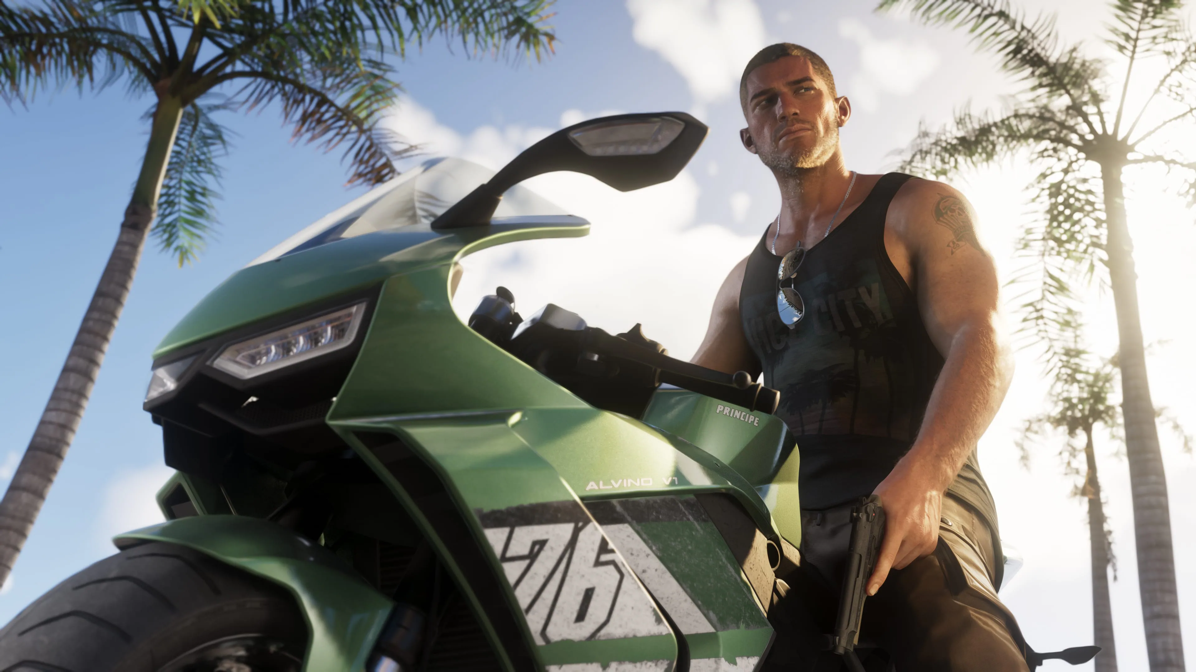 Jason Duval standing beside a green motorcycle beneath palm trees