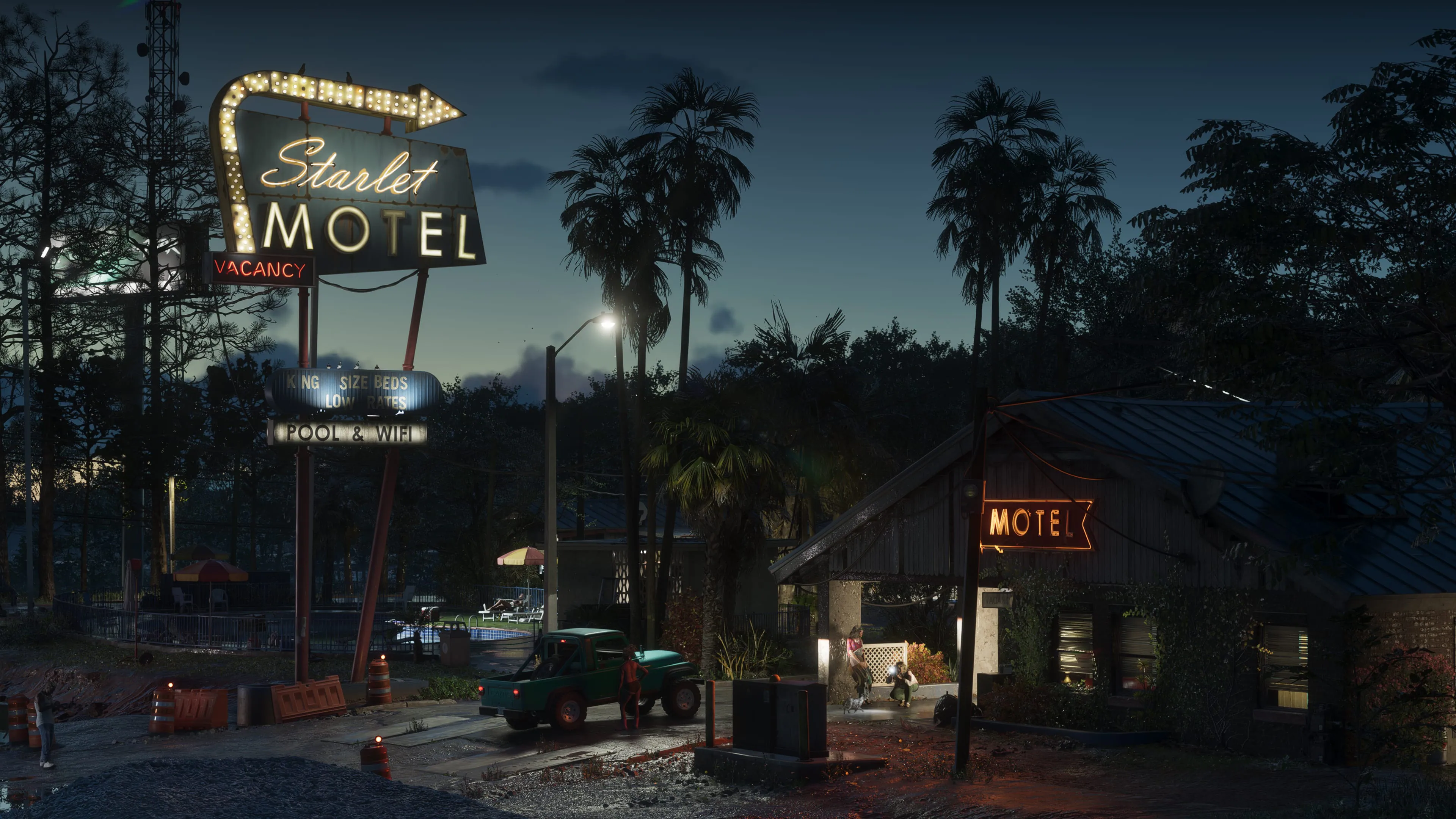 Roadside motel in Port Gellhorn illuminated by neon signs at night