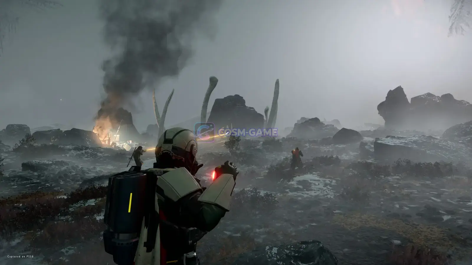 Armored Helldivers move through a foggy battlefield during an operation.