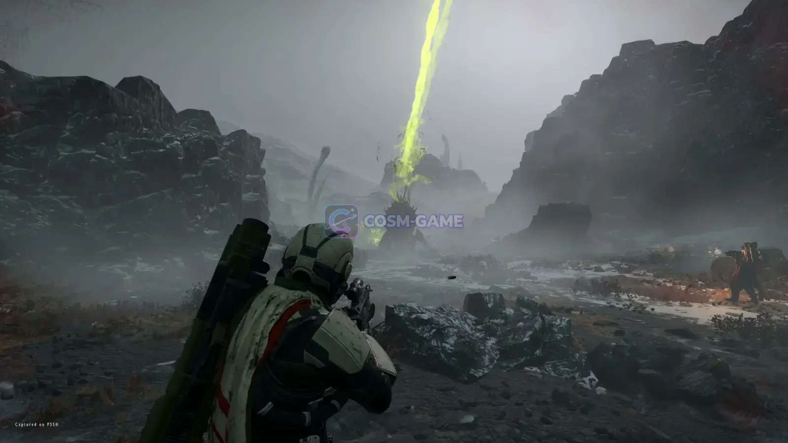 A Helldiver advances through rugged alien terrain with a weapon ready.