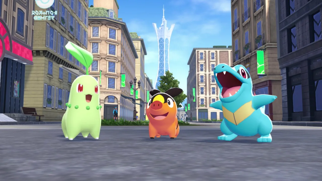 Chikorita, Tepig, and Totodile stand together on a street in Lumiose City.