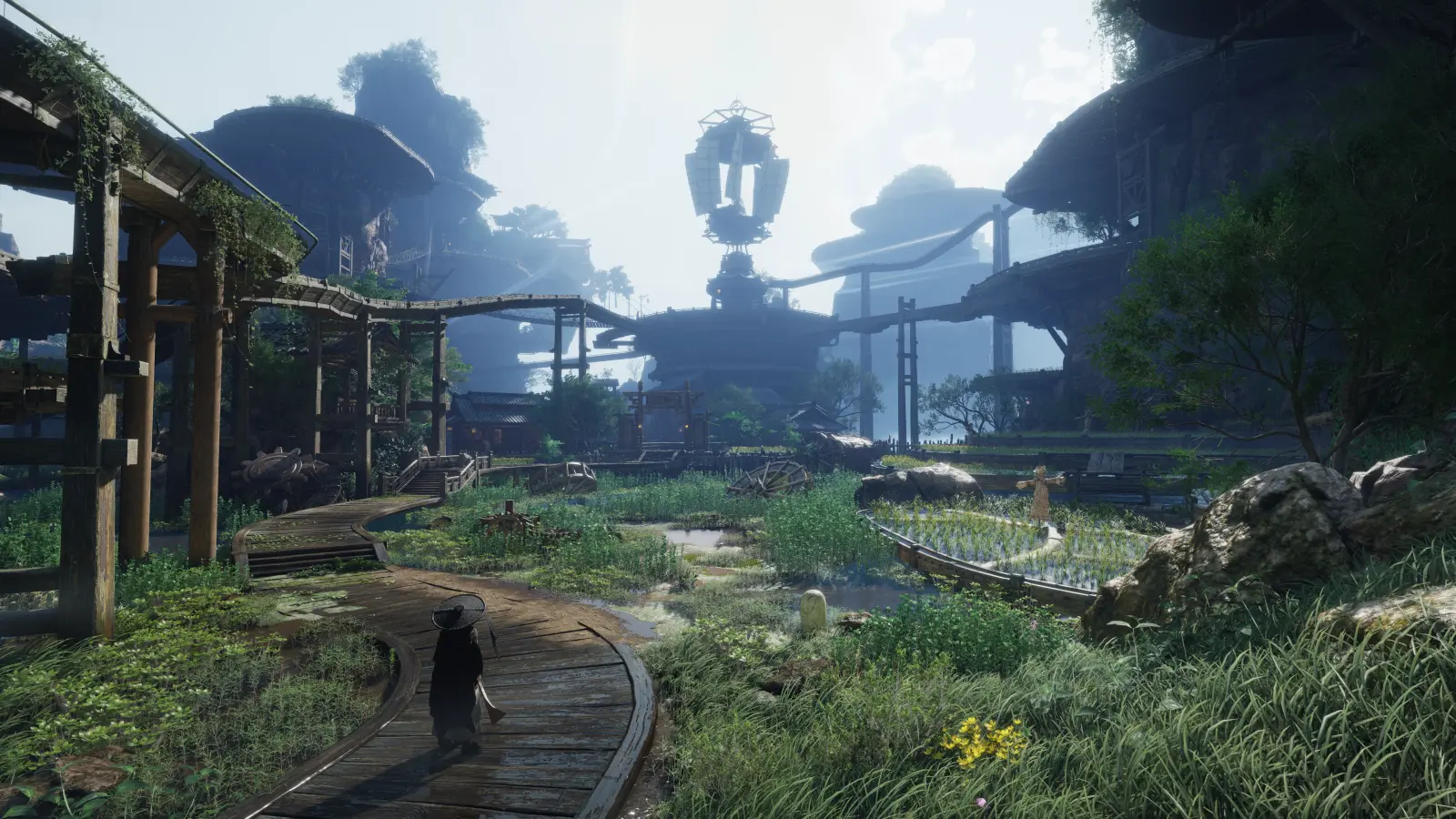 A Wanderer walks along wooden paths through a lush settlement of terraced gardens, water channels, and large mechanical structures.